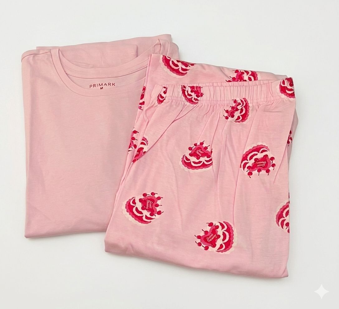This charming two-piece women's pajama set features a soft, light pink color theme.
